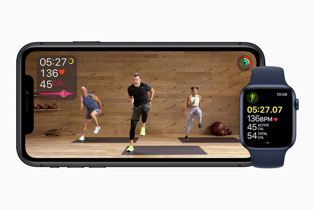 a fitness class on an iphone next to an apple watch